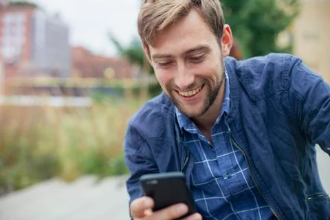 Man text messaging outdoors Stock Photos