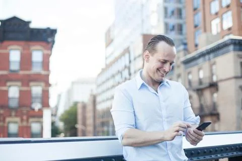 Man text messaging with smartphone Stock Photos