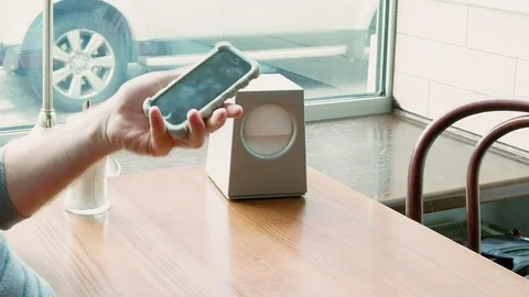 Man texting and browsing with mobile app in a cafe Stock Footage 69980148