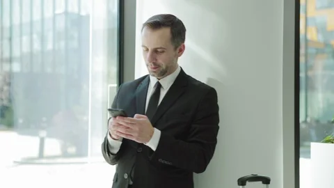 Man texting on cell phone while waiting in airport Stock Footage 108680830