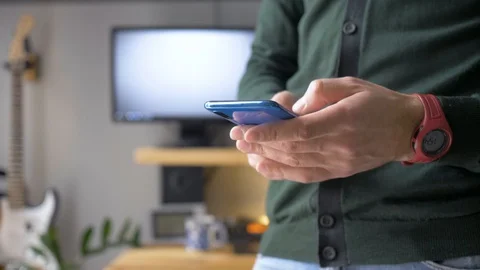 A man is texting on his smartphone. Stock Footage 129992214