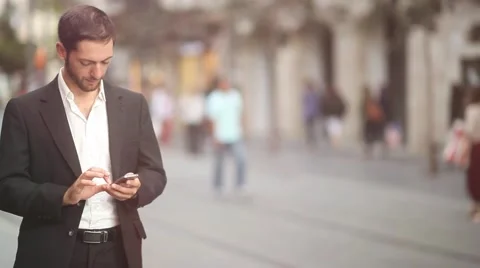 Man texting on Iphone in a urban environment [lens flare] Stock Footage 42254007