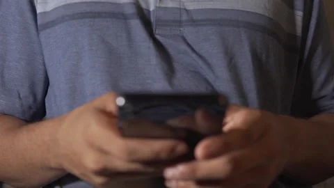 Man texting message on smartphone using thumbs Stock Footage 320968087