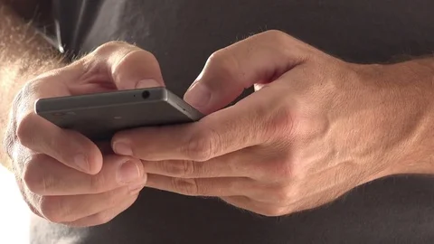 Man texting on mobile phone Stock Footage