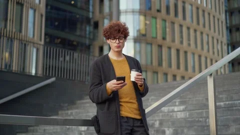 Man texting on phone standing on steps Stock Footage 139506835