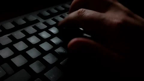 The man is texting quickly with one hand on a black keyboard. Stock Footage 141340065