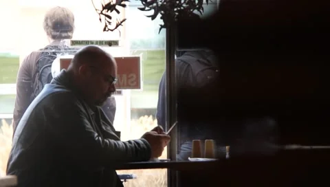 Man texting in restaurant Stock Footage 1196259