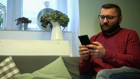 Man texting, sending sms on smartphone in cafe Stock Footage 70859319