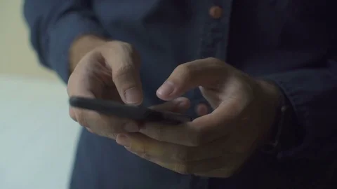 Man texting on smartphone. Close-up shot Stock Footage 79140817