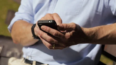 Man texting on smartphone outdoors Stock Footage 26292098