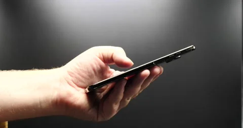 Man texting on smartphone side view isolated on black close up Video stock 205489156