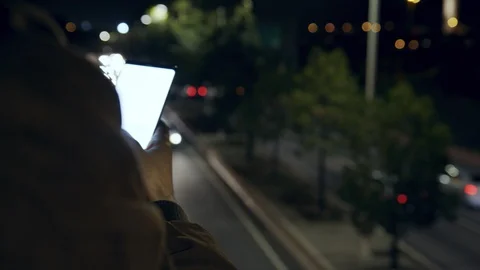 Man texting sms message on cell phone at night city highway on backgroung Stock-Footage 128033392