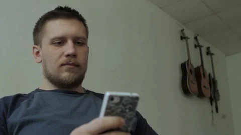 Man texting \ surfing web on the smartphone. Video stock 77325137