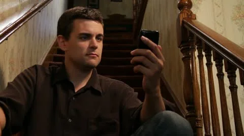 Man texting &amp; then talking on iPhone Stock Footage 11895001