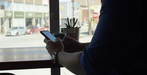 Man texting while drinking his coffee Stock Footage 108515068