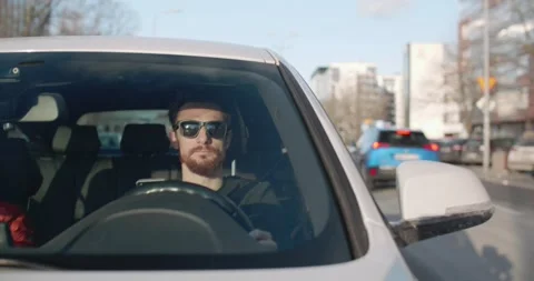 Man texting while driving car in the city downtown traffic in Warsaw Stock Footage 169716245