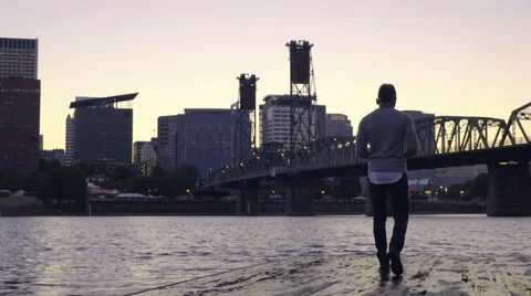 Man Texts And Walks To End Of Dock, Then Puts Phone Away To Enjoy City Views Stock Footage