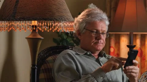 MAN TEXTS ON SMARTPHONE AT HOME Stock Footage 49219509