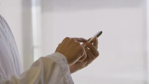 Man in thawb using a smartphone Stock Footage 127123685