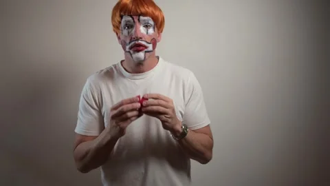 Man with theatrical makeup getting ready as a clown Stock-Footage 323804480