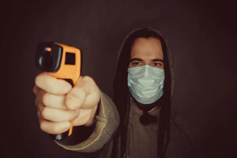 Man with thermometer gun Stock Photos