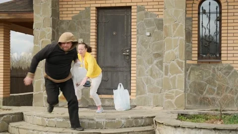 Man thief pulls out bag of groceries from woman from hand of woman 動画素材 131742506