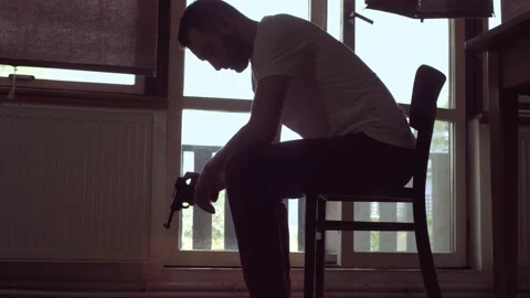 Man thinking about to commit suicide, holding gun in hand, depression Stock Footage 160224398