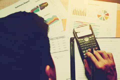 Man thinking about expenses with doing finance and calculate profit on desk.. Stock Photos
