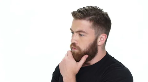 Man thinking about something and touching his bear Stock Footage 65016691