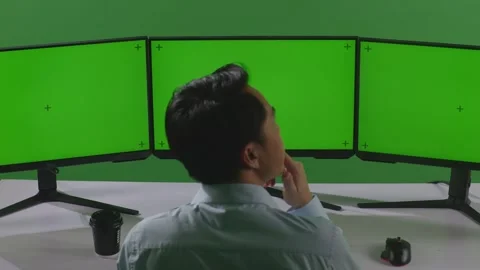 Man Thinking About Something While Working With Mock Up Multiple Computer Stock Footage 249633911