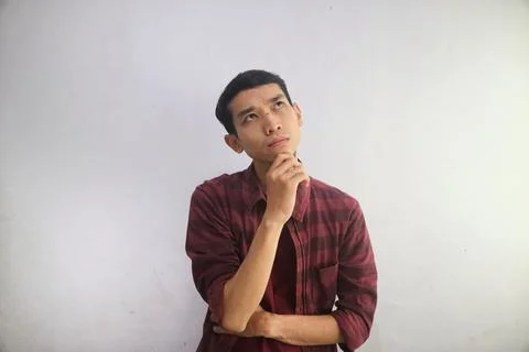 A man thinking about something while looking to his upper left corner Stock Photos