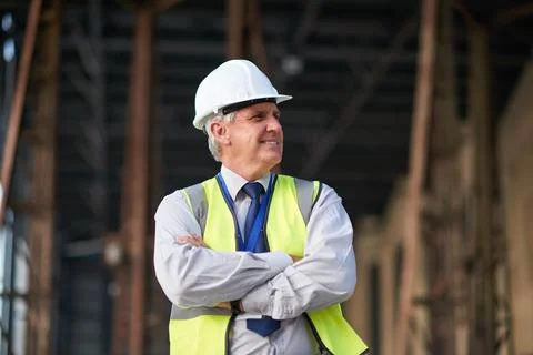 Man, thinking and construction with arms crossed in city, foreman or supervisor Stock Photos