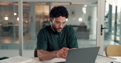 Man, thinking and laptop in office for report, reading and project management at Stock Footage 314090056