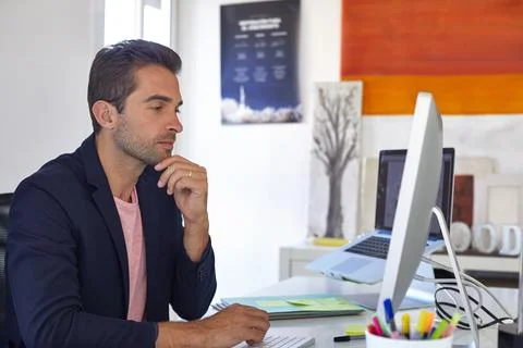 Man, thinking and reading in office with computer, review and consider grap.. Stock Photos