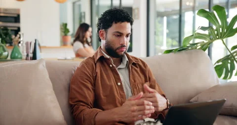 Man, thinking and remote work with laptop on sofa with review, problem solving Stock Footage 303474912