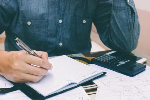 Man thinking and stress in problem with expenses at home office. Stock Photos