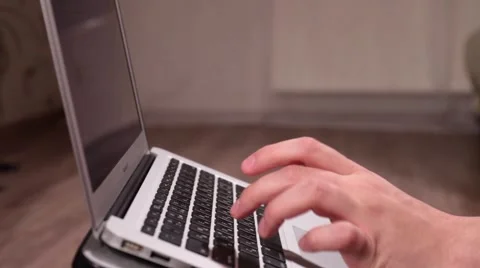 A man is thinking and typing on laptop keyboard Stock Footage 58395380