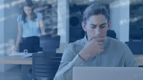 Man thinking and typing while coworker sorting binder starting code overlay on Stock Footage 329910057