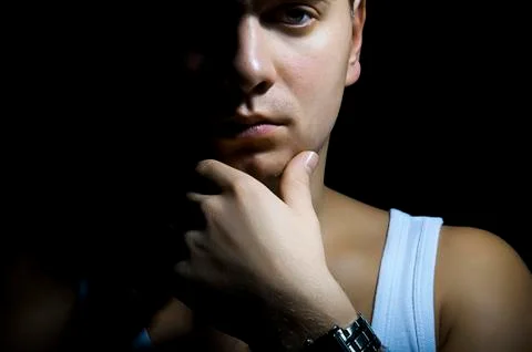 Man thinking on a black background Stock Photos