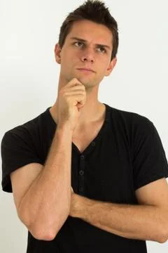 Man thinking with hand on face Foto stock