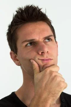 Man thinking with hand on face Foto stock