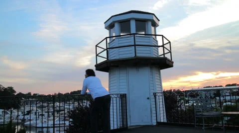 Man thinking as he over looks boat harbor Stock Footage 28058741