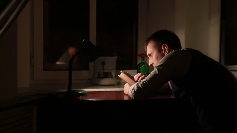 The man thinking over a book Stockbeeldmateriaal 70246011