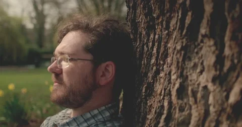Man thinking sitting under tree Stock Footage 60793866