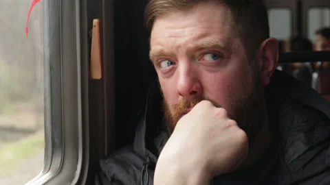 Man is thinking in the train, looking through the window. Stock Footage 188841506