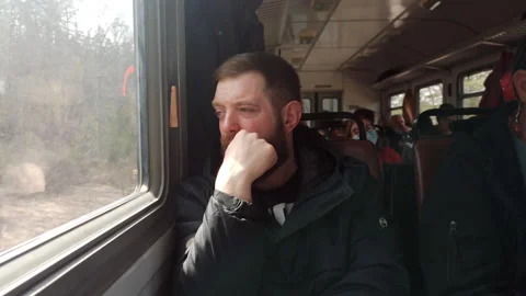 Man is thinking in the train, looking through the window. Stock Footage 188844542