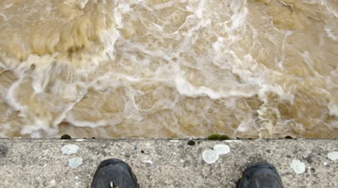 Man thinking whether to jump into the stormy river Stock Footage 38310462