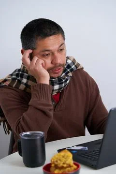 Man thinking while making a video call Stock Photos