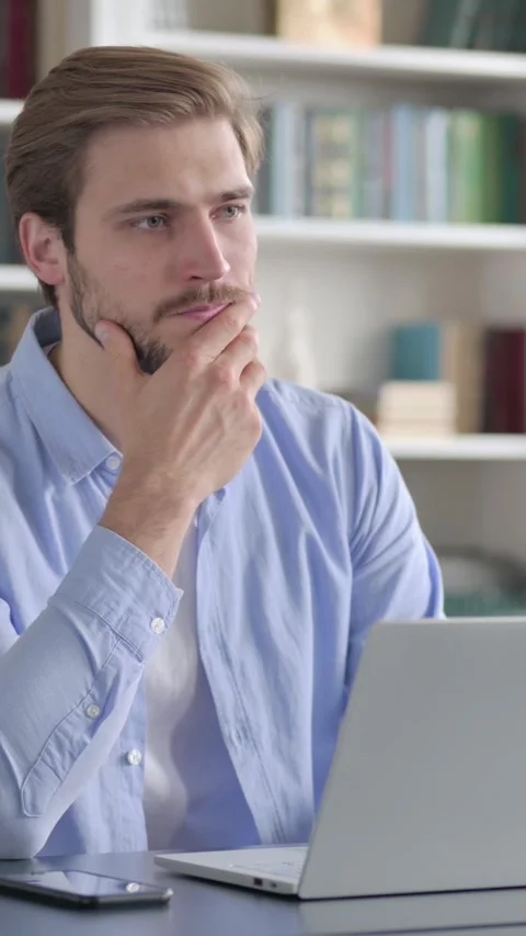 Man Thinking while Working on Laptop in Office, Vertical Video Stock Footage 339577765