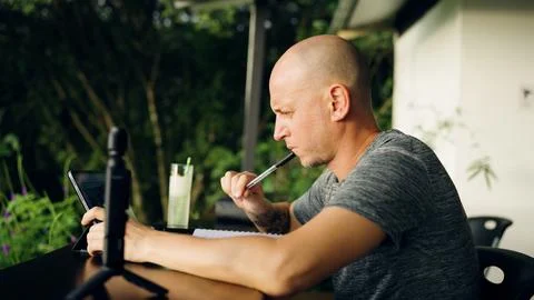 Man thinking while working remotely in outdoor office Stock Photos